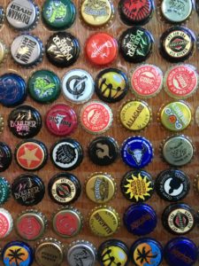 colorful beer bottle caps on a display board
