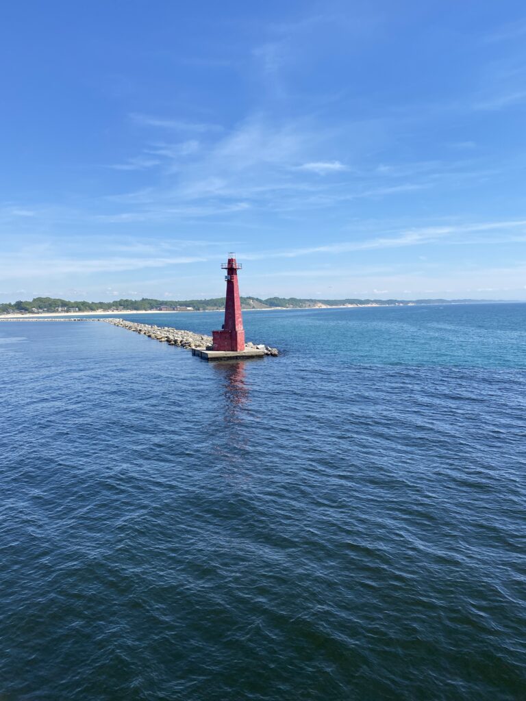 cannabis tourism is helped by Michigan's two cross lake ferries from Wisconsin. This photo taken from the Lake Express ferry shows the red lighthouse at the Muskegon harbor.